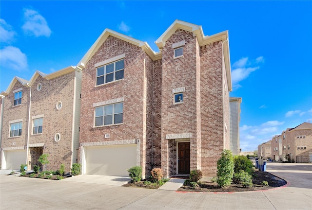 11509 Main Ash, Houston, TX 77025 - view of front of house with brick siding, concrete driveway, a residential view, and an attached garage