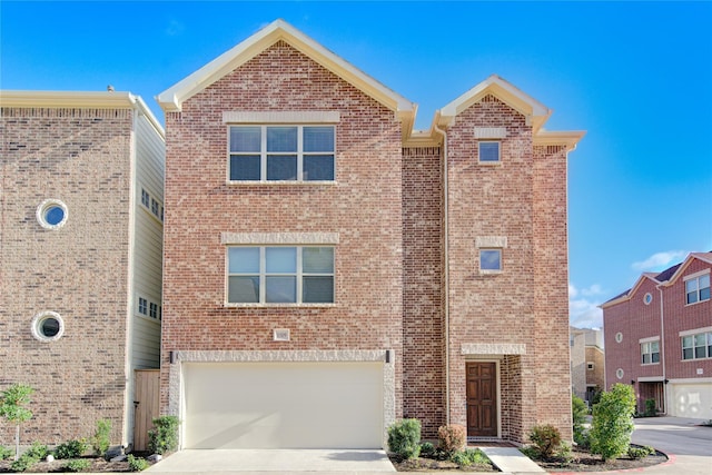 11509 Main Ash, Houston, TX 77025 - view of front of home with brick siding, an attached garage, and driveway