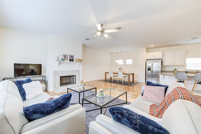 11509 Main Ash, Houston, TX 77025 - living room featuring a ceiling fan, light wood-type flooring, a high end fireplace, baseboards, and recessed lighting