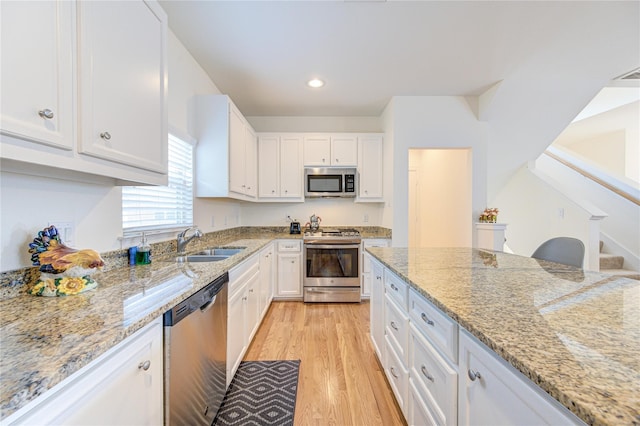 11509 Main Ash, Houston, TX 77025 - kitchen featuring stainless steel appliances, a sink, white cabinets, light stone countertops, and recessed lighting