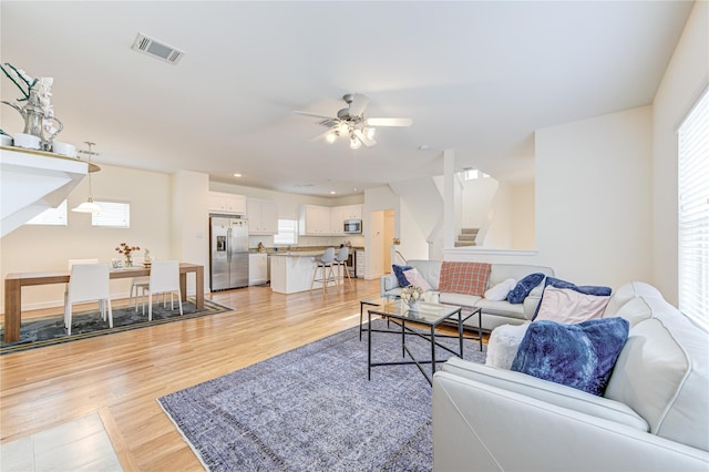 11509 Main Ash, Houston, TX 77025 - living area with ceiling fan, light wood-style floors, stairs, and recessed lighting