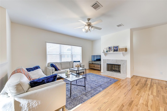 11509 Main Ash, Houston, TX 77025 - living area featuring a ceiling fan, wood finished floors, a fireplace, and baseboards
