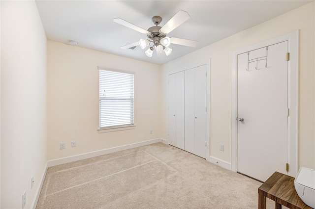 11509 Main Ash, Houston, TX 77025 - unfurnished bedroom featuring two closets, light colored carpet, baseboards, and a ceiling fan