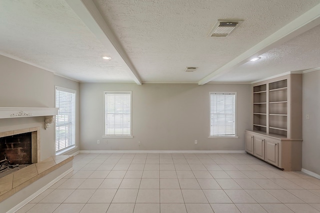 7803 Hurst Forest Dr, Humble, TX 77346 - unfurnished living room with a textured ceiling, beamed ceiling, a fireplace, plenty of natural light, and baseboards