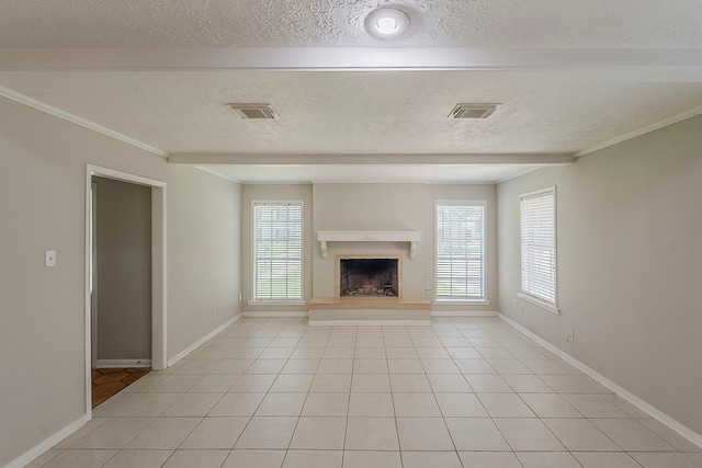 7803 Hurst Forest Dr, Humble, TX 77346 - unfurnished living room featuring healthy amount of natural light, a fireplace with raised hearth, baseboards, a textured ceiling, and crown molding