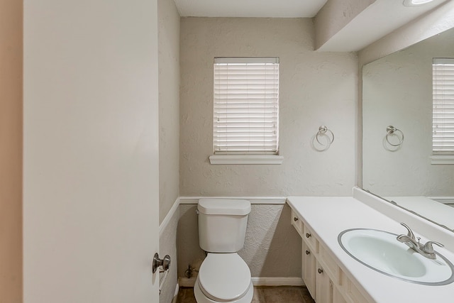 7803 Hurst Forest Dr, Humble, TX 77346 - half bath with toilet, healthy amount of natural light, vanity, and a textured wall