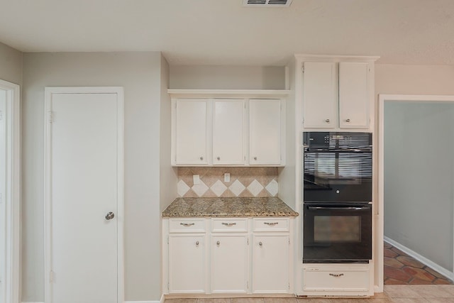 7803 Hurst Forest Dr, Humble, TX 77346 - kitchen featuring tasteful backsplash, white cabinets, light tile patterned flooring, and baseboards