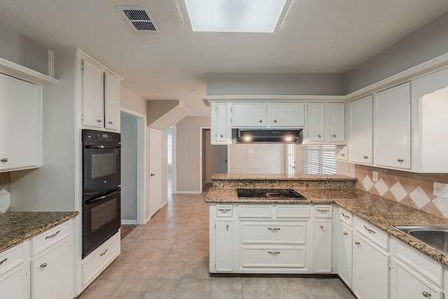 7803 Hurst Forest Dr, Humble, TX 77346 - kitchen featuring black appliances, under cabinet range hood, a peninsula, and white cabinets