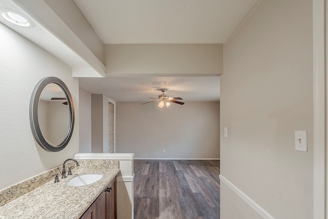 7803 Hurst Forest Dr, Humble, TX 77346 - bathroom featuring a ceiling fan, wood finished floors, vanity, and baseboards