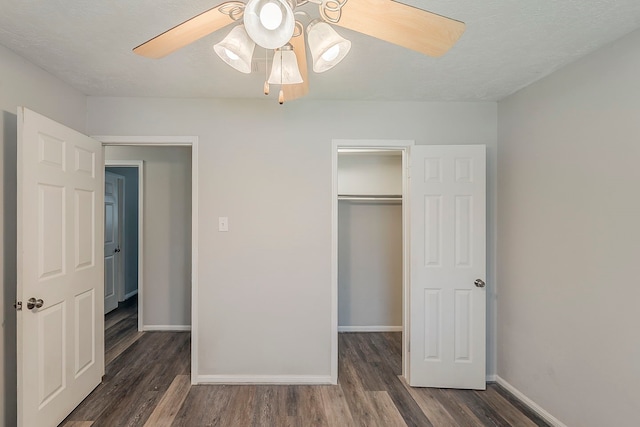 7803 Hurst Forest Dr, Humble, TX 77346 - unfurnished bedroom featuring baseboards, wood finished floors, a closet, and a ceiling fan