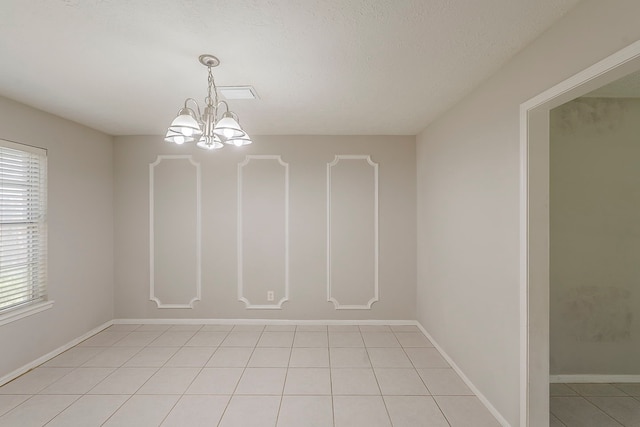 7803 Hurst Forest Dr, Humble, TX 77346 - unfurnished room featuring a chandelier, light tile patterned floors, and baseboards