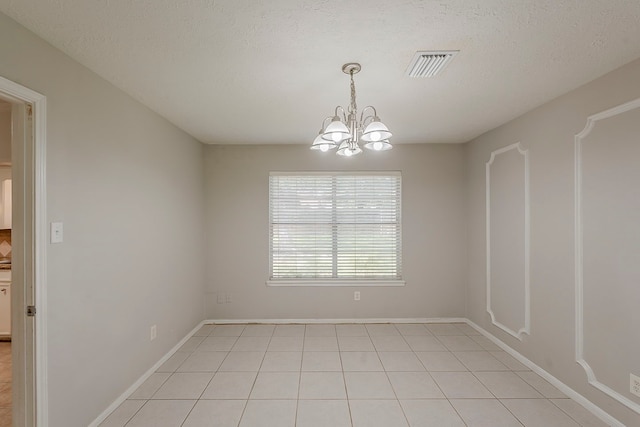 7803 Hurst Forest Dr, Humble, TX 77346 - unfurnished room with a chandelier, light tile patterned floors, and baseboards