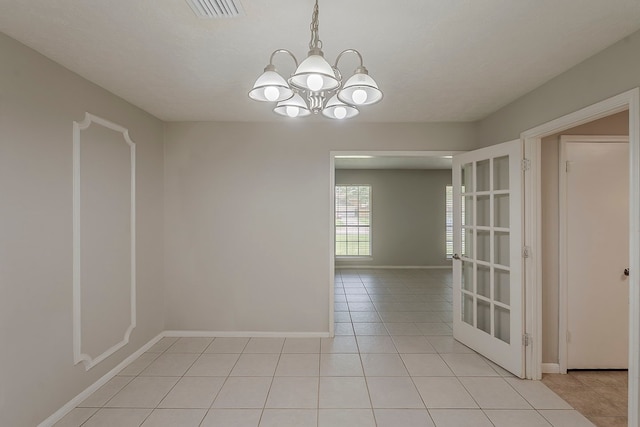 7803 Hurst Forest Dr, Humble, TX 77346 - unfurnished room featuring light tile patterned floors, a chandelier, and baseboards