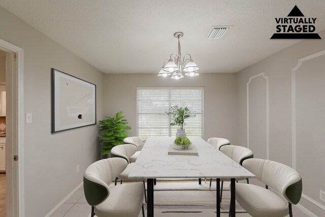 7803 Hurst Forest Dr, Humble, TX 77346 - dining area featuring a chandelier, baseboards, and light tile patterned floors