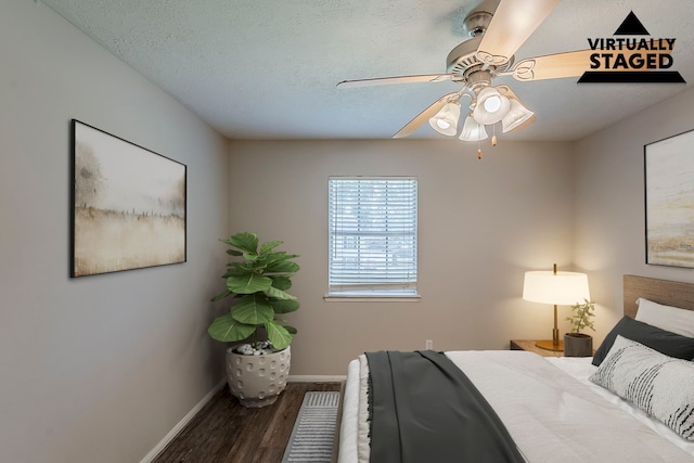 7803 Hurst Forest Dr, Humble, TX 77346 - bedroom with baseboards, wood finished floors, a ceiling fan, and a textured ceiling