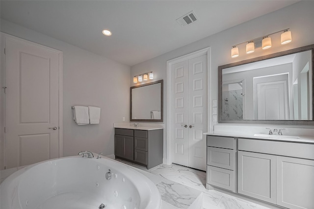 11430 Bush Clover Dr, Cypress, TX 77433 - bathroom with a whirlpool tub, recessed lighting, two vanities, and marble finish floors