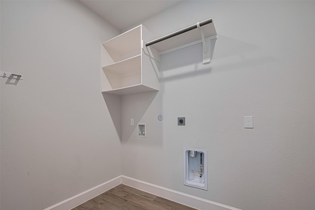 11430 Bush Clover Dr, Cypress, TX 77433 - clothes washing area with electric dryer hookup, hookup for a gas dryer, dark wood-style flooring, hookup for a washing machine, and baseboards