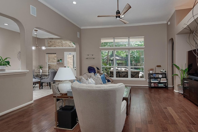 87 S Bluff Creek Cir, The Woodlands, TX 77382 - living room featuring a ceiling fan, arched walkways, dark wood-type flooring, ornamental molding, and recessed lighting