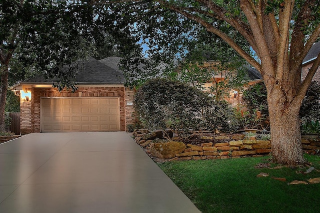 87 S Bluff Creek Cir, The Woodlands, TX 77382 - view of front facade with brick siding, driveway, an attached garage, and a shingled roof