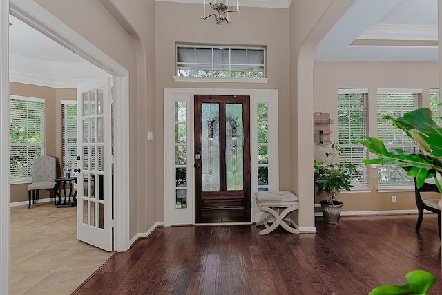 87 S Bluff Creek Cir, The Woodlands, TX 77382 - foyer entrance with baseboards, wood finished floors, crown molding, and arched walkways