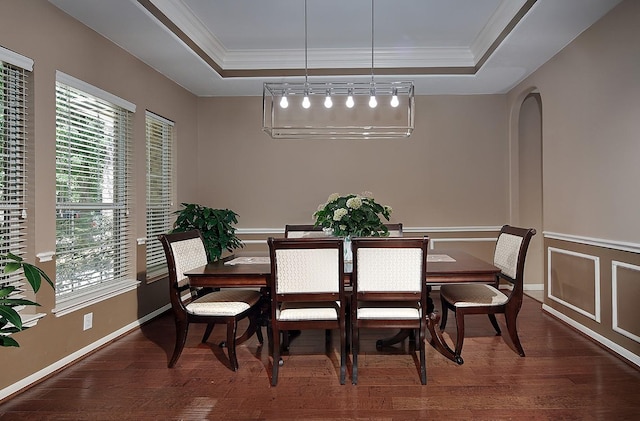 87 S Bluff Creek Cir, The Woodlands, TX 77382 - dining space with a tray ceiling, wood finished floors, crown molding, and arched walkways