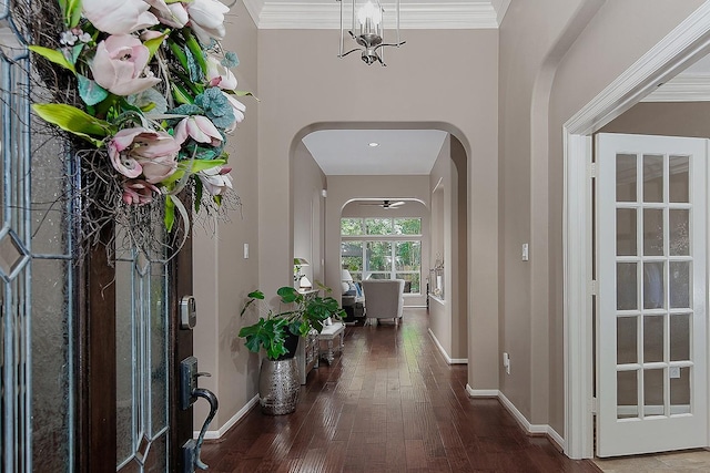 87 S Bluff Creek Cir, The Woodlands, TX 77382 - foyer featuring arched walkways, hardwood / wood-style floors, baseboards, and crown molding
