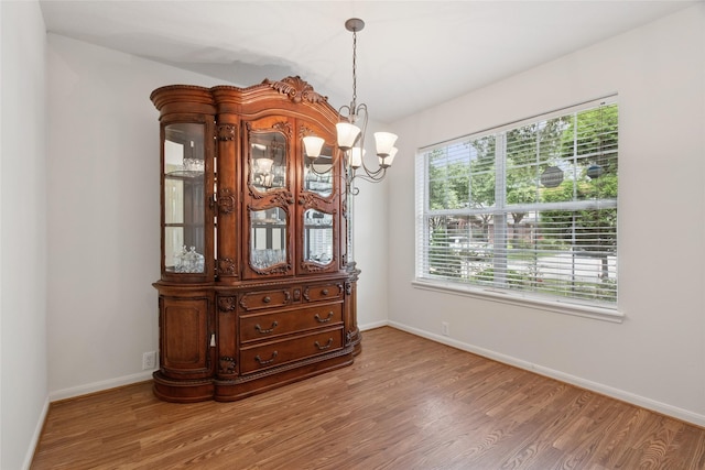 4705 Foster Hill Ct, Houston, TX 77345 - dining space featuring wood finished floors, a chandelier, and baseboards