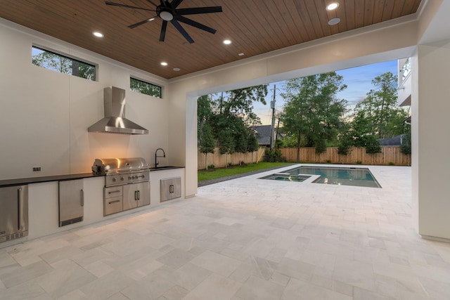 view of patio / terrace with an outdoor kitchen, a fenced backyard, a grill, ceiling fan, and a sink