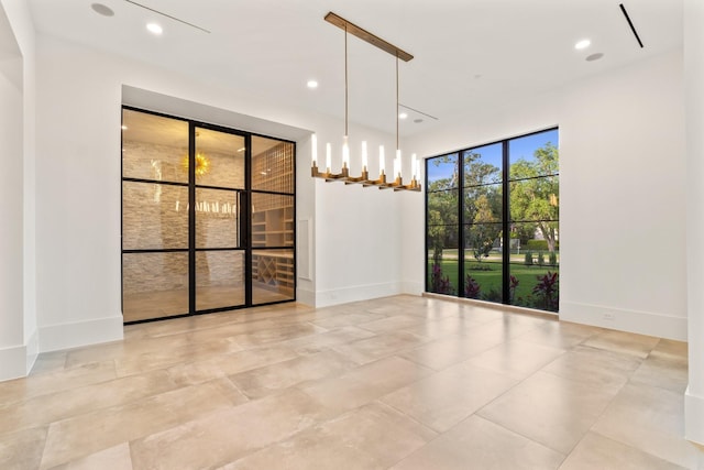 empty room featuring baseboards and recessed lighting
