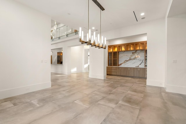 unfurnished dining area featuring baseboards and recessed lighting