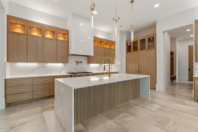kitchen featuring modern cabinets, a sink, glass insert cabinets, and recessed lighting