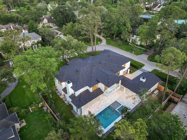 aerial view of property and surrounding area featuring a pool
