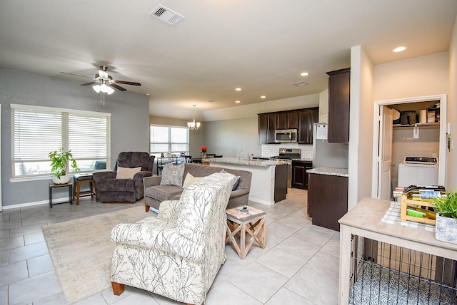 7303 Barrington Ridge Ln, Richmond, TX 77407 - living area with light tile patterned flooring, a ceiling fan, washer / dryer, baseboards, and recessed lighting