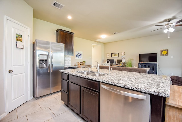 7303 Barrington Ridge Ln, Richmond, TX 77407 - kitchen featuring stainless steel appliances, a sink, open floor plan, dark brown cabinets, and ceiling fan