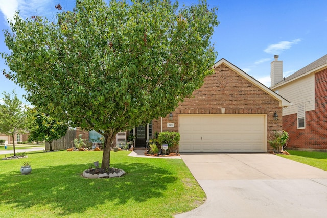 7103 Uther Ct, Spring, TX 77379 - view of front of home with brick siding, driveway, a garage, and a front lawn