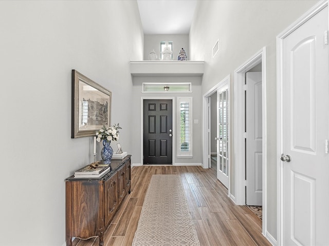711 Summer Trace Ln, Richmond, TX 77406 - entryway with wood finished floors, healthy amount of natural light, a high ceiling, and baseboards