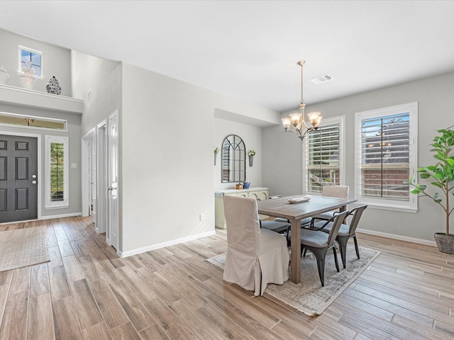 711 Summer Trace Ln, Richmond, TX 77406 - dining space with a chandelier, light wood-style floors, and baseboards