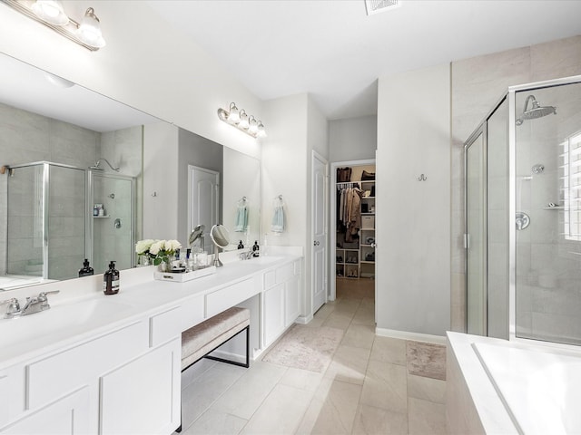 711 Summer Trace Ln, Richmond, TX 77406 - bathroom with a shower stall, a walk in closet, double vanity, and a tub to relax in