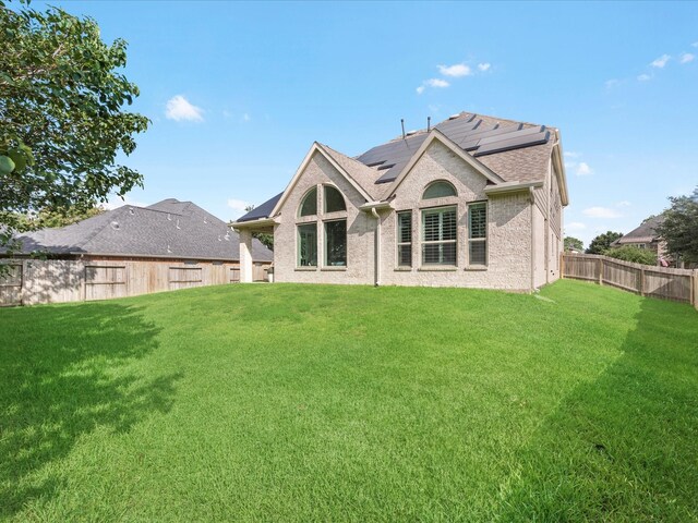 711 Summer Trace Ln, Richmond, TX 77406 - back of house with solar panels and roof with shingles