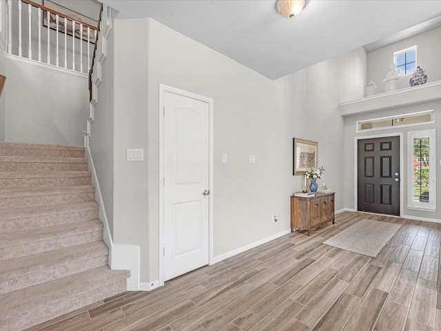 711 Summer Trace Ln, Richmond, TX 77406 - foyer entrance featuring stairway, light wood-type flooring, baseboards, and a high ceiling