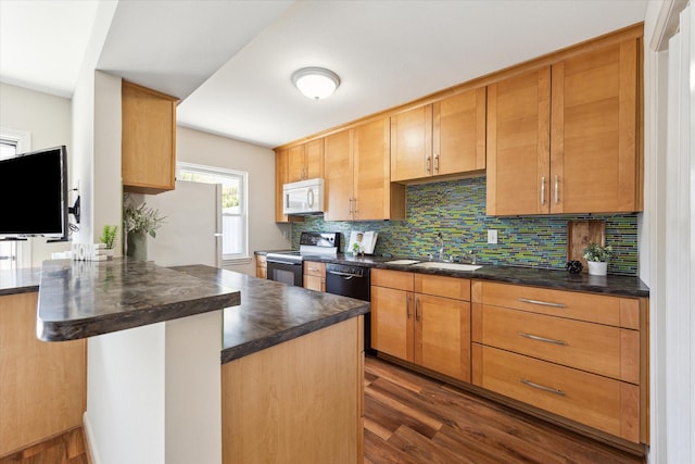 2065 Winrock Blvd Unit 55, Houston, TX 77057 - kitchen with white appliances, dark countertops, dark wood-type flooring, decorative backsplash, and a sink