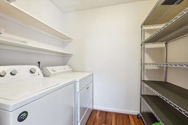 2065 Winrock Blvd Unit 55, Houston, TX 77057 - laundry area featuring washing machine and clothes dryer, baseboards, and dark wood finished floors