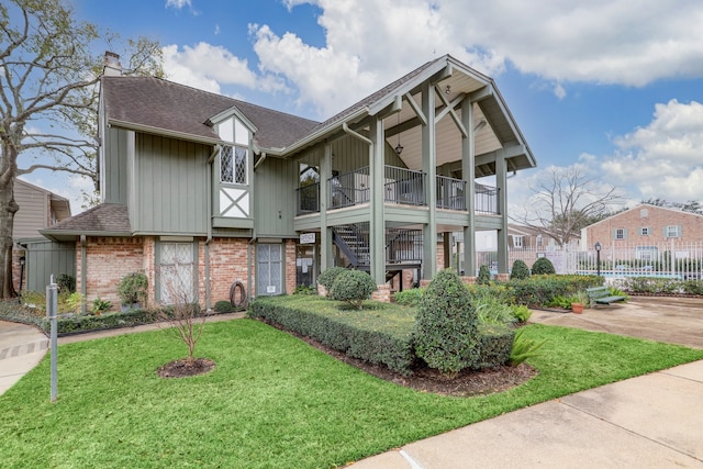 2065 Winrock Blvd Unit 55, Houston, TX 77057 - view of front of property with board and batten siding, brick siding, a chimney, roof with shingles, and stairway