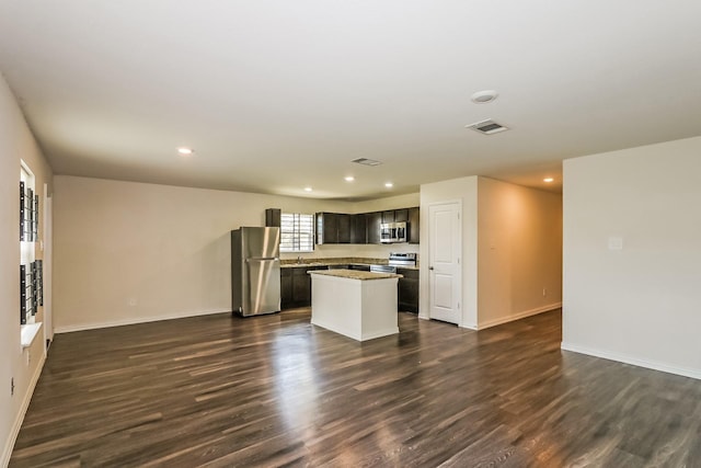 2203 Pearl St, Houston, TX 77029 - kitchen with appliances with stainless steel finishes, dark wood-style flooring, a kitchen island, recessed lighting, and baseboards