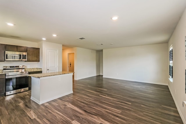 2203 Pearl St, Houston, TX 77029 - kitchen featuring appliances with stainless steel finishes, a kitchen island, dark wood-style flooring, dark brown cabinets, and recessed lighting