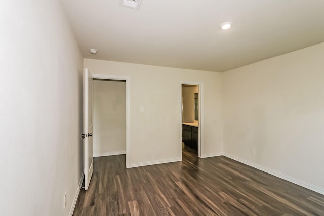 2203 Pearl St, Houston, TX 77029 - unfurnished bedroom featuring dark wood-style floors, baseboards, and recessed lighting