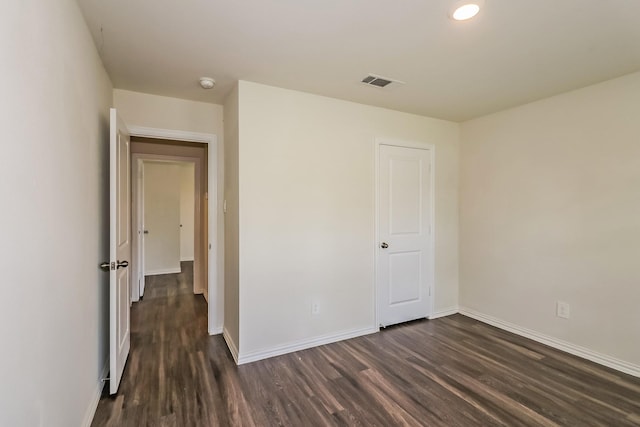 2203 Pearl St, Houston, TX 77029 - unfurnished bedroom with dark wood-style flooring and baseboards