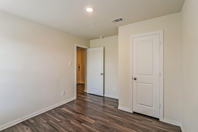 2203 Pearl St, Houston, TX 77029 - unfurnished bedroom featuring dark wood-style floors and baseboards