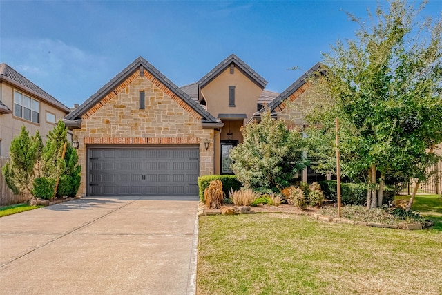 5123 Wheaton Park Dr, Sugar Land, TX 77479 - view of front of house featuring stone siding, a front yard, concrete driveway, and a garage