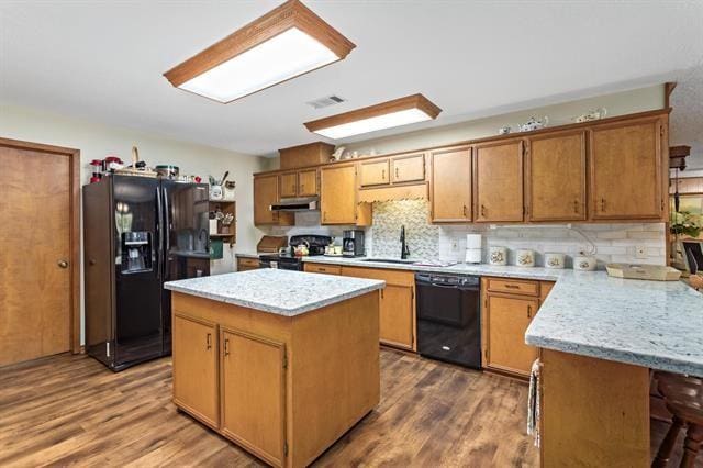 527 E Walton Rd, Lumberton, TX 77657 - kitchen featuring black appliances, under cabinet range hood, a sink, and dark wood-style floors